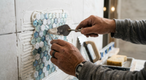 Close-up shot of a professional contractor hands installing high-quality mosaic tiles in a luxurious